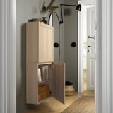 Wooden BESTÅ wall cabinet with open door, adjustable hinges, soft-close, and push-open functions.