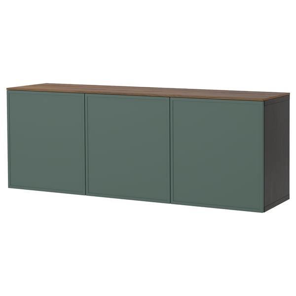 A green ikea BESTÅ sideboard with wood top. Its rectangular, large, with three closed cabinets for storage.