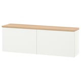 A white BESTÅ storage unit with an oak top, featuring two closed sections. Modern, wall-mounted, with adjustable shelves inside.