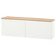A white BESTÅ storage unit with an oak top, featuring two closed sections. Modern, wall-mounted, with adjustable shelves inside.