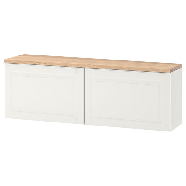 White BESTÅ storage unit with oak top, rectangular design, wall-mountable.