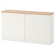 A white BESTÅ storage unit with a wooden top.