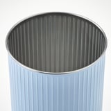 A light blue, fluted waste bin with a tinplated steel finish. The bin appears sturdy and clean, ready for use.