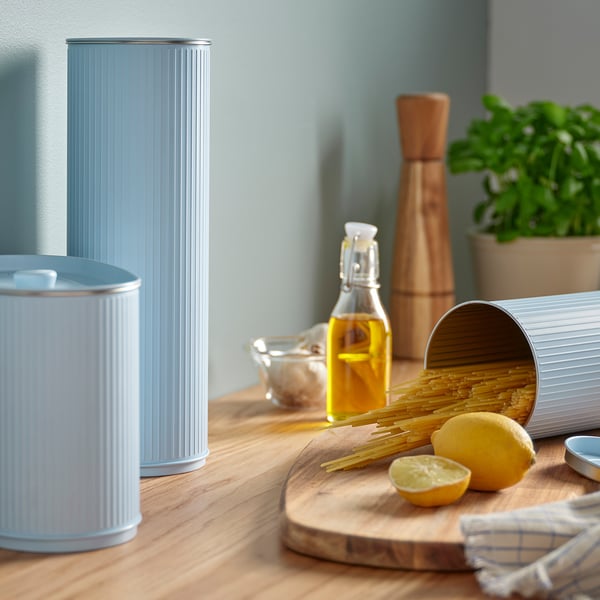 Tin canisters on table with cooking ingredients