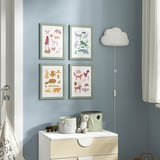 Childs room with animal prints, cloud lamp, toy chest.