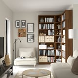 Modern living room with BILLY bookcase, sofa, chaise, lamp, and coffee table. Bright, minimalist, cozy.