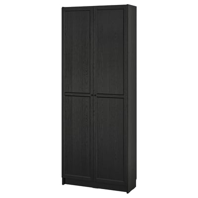 Black BILLY bookcase, sleek design. Tall, rectangular with adjustable shelves. Dark wood finish, closed doors.