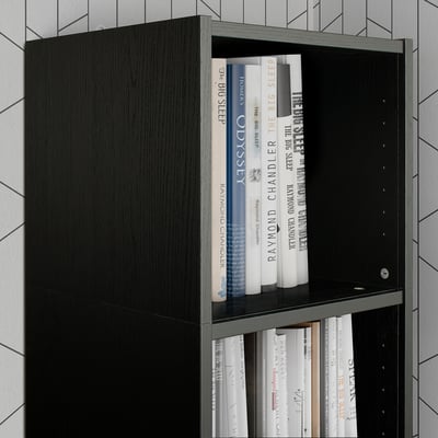 Black BILLY bookcase shelf with books. Tall unit holding various sized books. Modern, sleek design. Suitable for vertical storage.