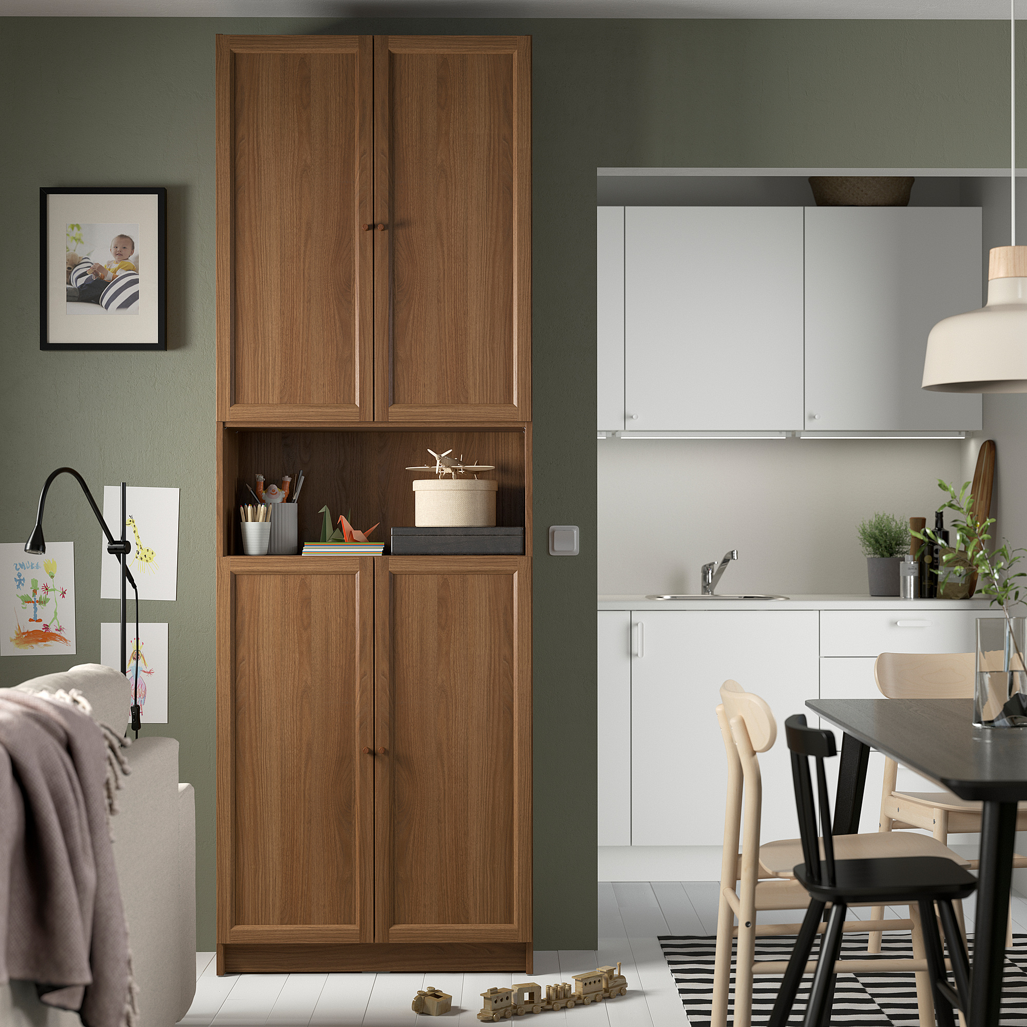 Cozy kitchen with BILLY bookcase, dining area, toys, and green wall.
