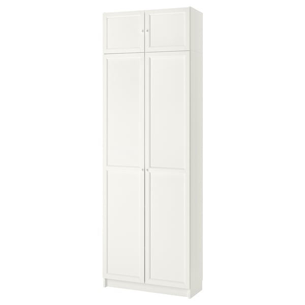 A white, tall BILLY bookcase with four closed doors. It is sleek and rectangular, made of particleboard and fiberboard, ideal for storage.