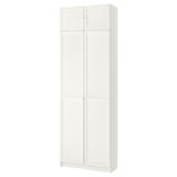 A white, tall BILLY bookcase with four closed doors. It is sleek and rectangular, made of particleboard and fiberboard, ideal for storage.