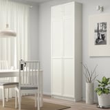 Minimalist dining room with BILLY bookcase, table, chairs, plants, photo.