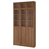 Tall wooden BILLY bookcase with glass doors.