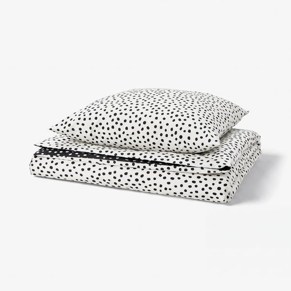 The BJÖRKGRÅMAL duvet cover set with black dots on a white background, featuring a soft cotton/viscose blend for comfort.