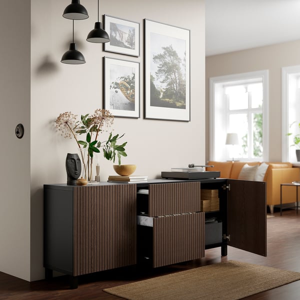 Modern living room with BJÖRKÖVIKEN cabinet, featuring oak doors, decorative items, and wall art.