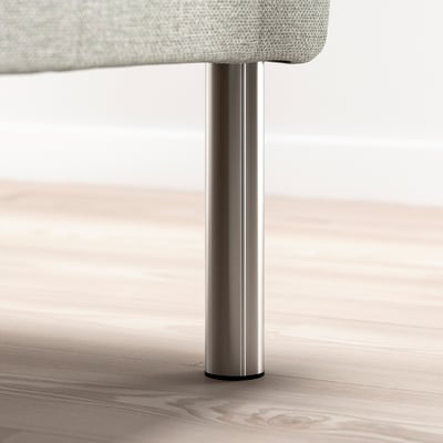 Metal leg supporting a fabric-covered furniture base, likely part of a bed frame.