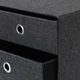 Black fabric storage box with metal handles, stitched edges, and folded top.