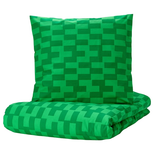 The BLÅSKATA green pixelated duvet set a vibrant green checkered pattern on a rectangular comforter and pillow, made from soft cotton and viscose.