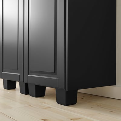 Black cabinet with adjustable feet for steady support on uneven floors.