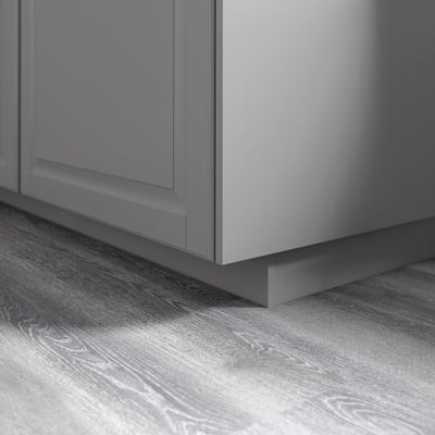 Gray kitchen cabinet plinths on wooden floor, creating a warm and traditional look, fitting metod series.