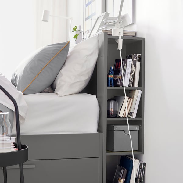 Modern bed frame with built-in storage drawers and headboard shelves, perfect for small spaces.