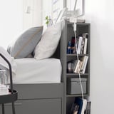 Modern bed frame with built-in storage drawers and headboard shelves, perfect for small spaces.