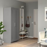 Gray BRIMNES wardrobe in corner, reflects modern room decor with mirror and shoe rack.