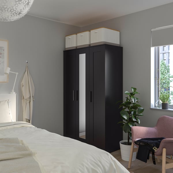 Black BRIMNES wardrobe with mirror in bedroom.