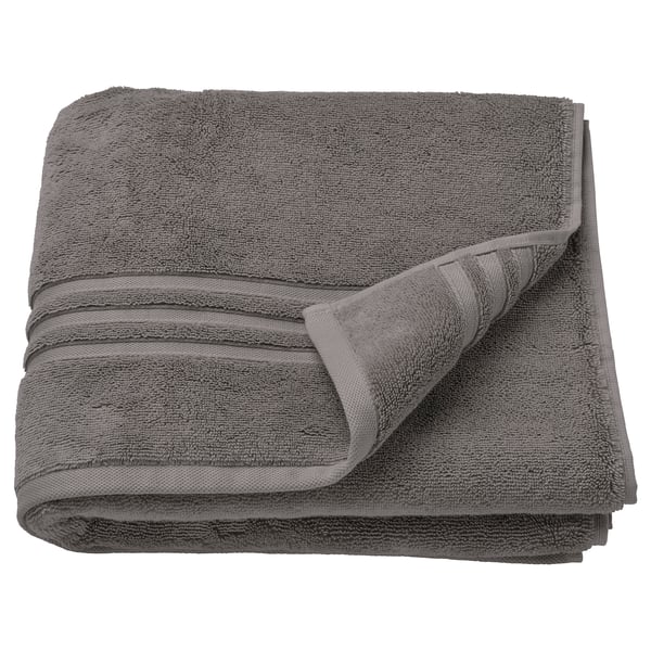 A neatly folded, dark grey BROKGLIM towel made of 100% organic cotton, featuring a woven border and square shape.