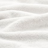 Soft organic cotton towels, plush and textured, folded neatly.