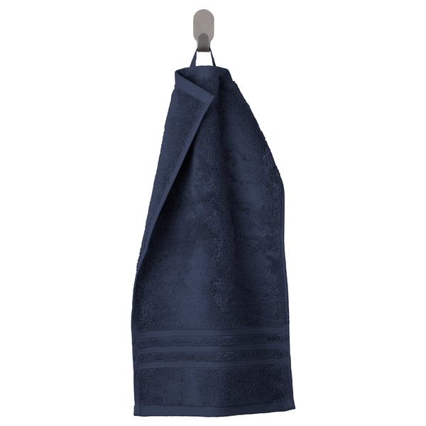 Dark blue towels striped and bordered, soft and absorbent, hang neatly on silver hook.