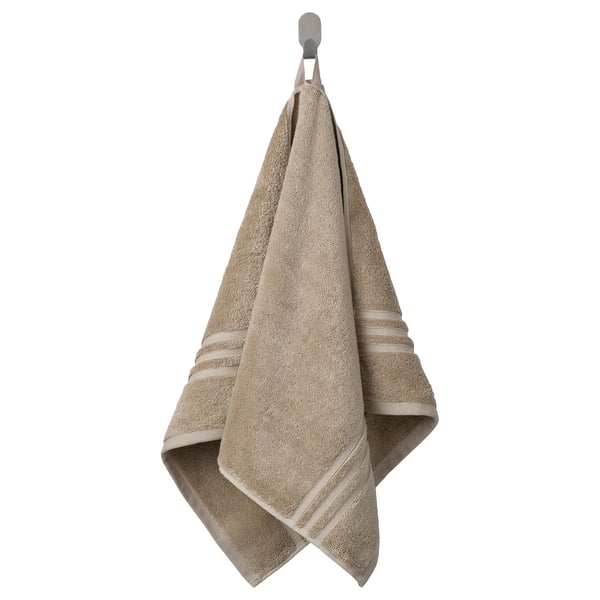 BROKGLIM towel, beige, organic cotton, folded, elegant border.