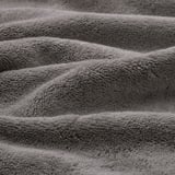 Folded organic cotton towel, soft, thick, textured, high-quality fabric.