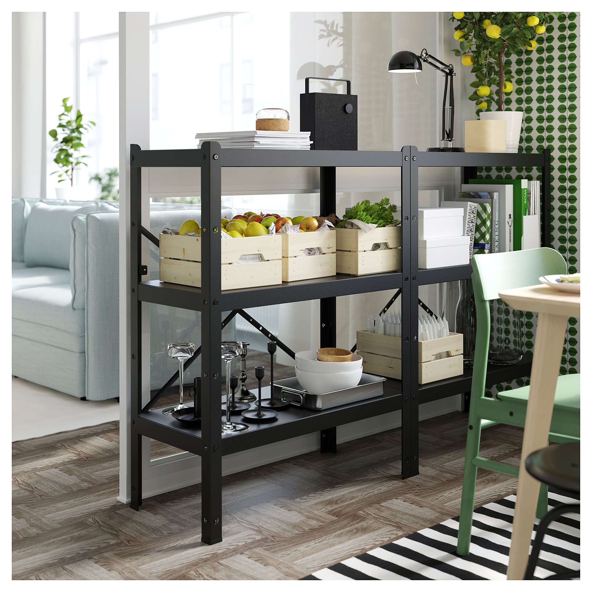 Black metal storage shelf named BROR, versatile for kitchen or dining room, holding wooden crates with fruits and kitchenware.