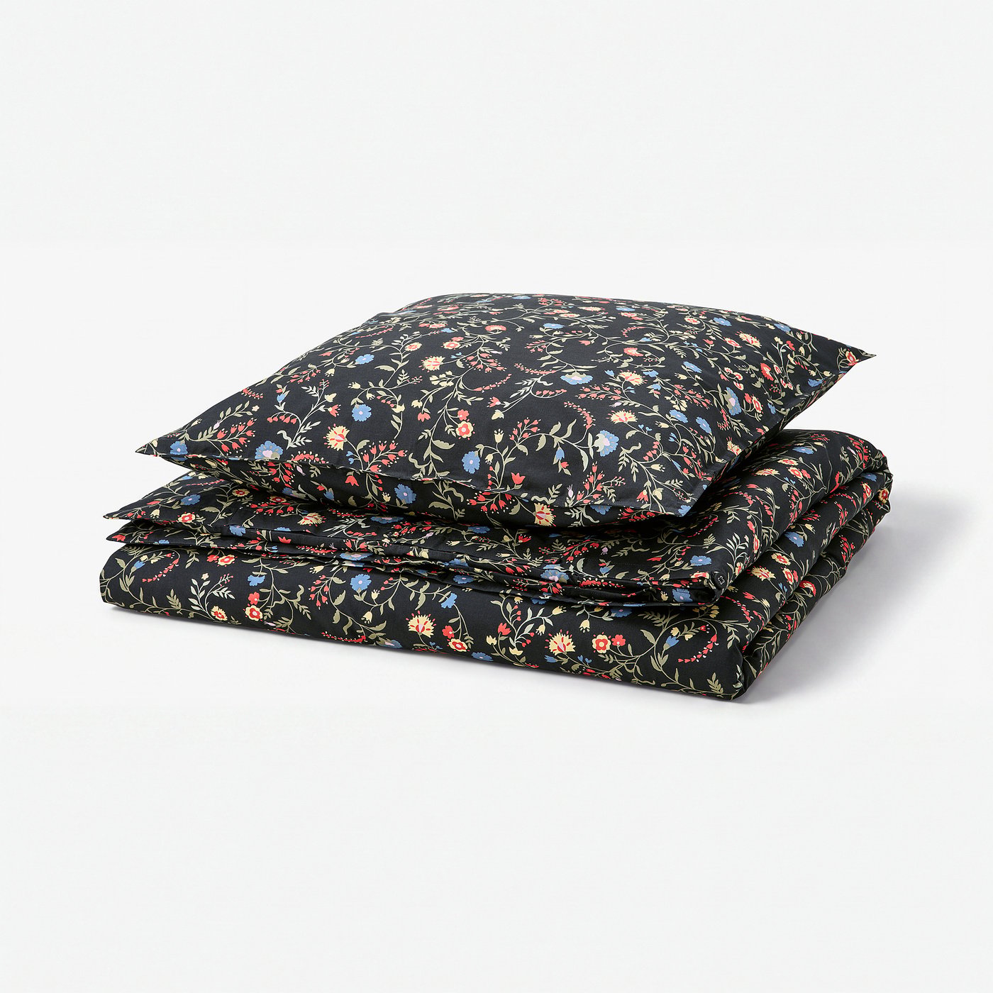 Black duvet set with colourful floral print, made of 100% organic cotton, neatly folded.
