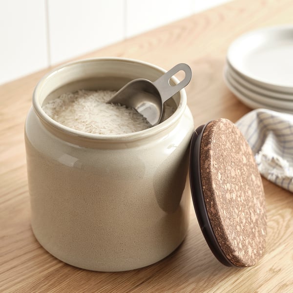 Beige stoneware jar with cork lid & stainless steel scoop for dry goods like rice.