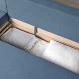 Sofa-bed reveals storage.