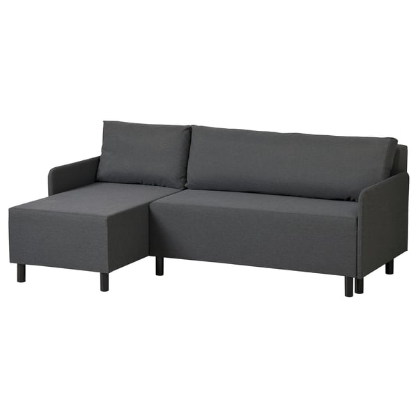 A dark grey BRUKSVARA l-shaped sofa-bed. It has a modern design with tapered black legs, and built-in storage for convenience.
