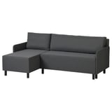A dark grey BRUKSVARA l-shaped sofa-bed. It has a modern design with tapered black legs, and built-in storage for convenience.