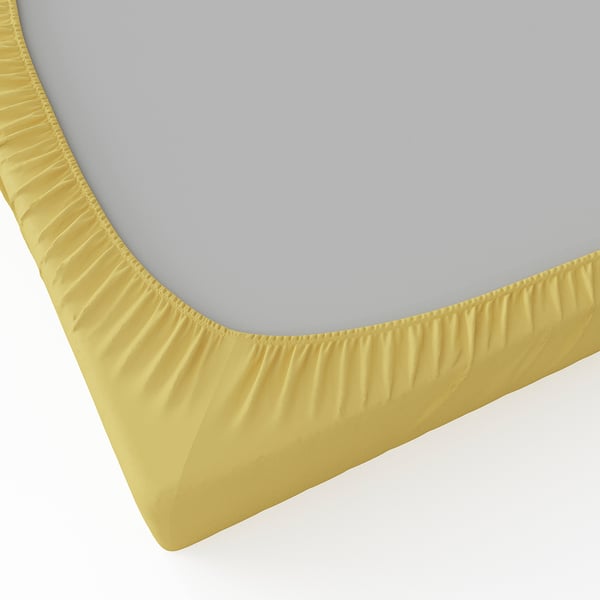 A fitted sheet in bright yellow with elastic edges, designed to fit mattresses up to 16 cm thick. Made from soft, smooth, 100% recycled polyester.