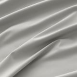 Close-up of luxurious, textured fabric; smooth, elegant weave; likely a high-quality curtain.