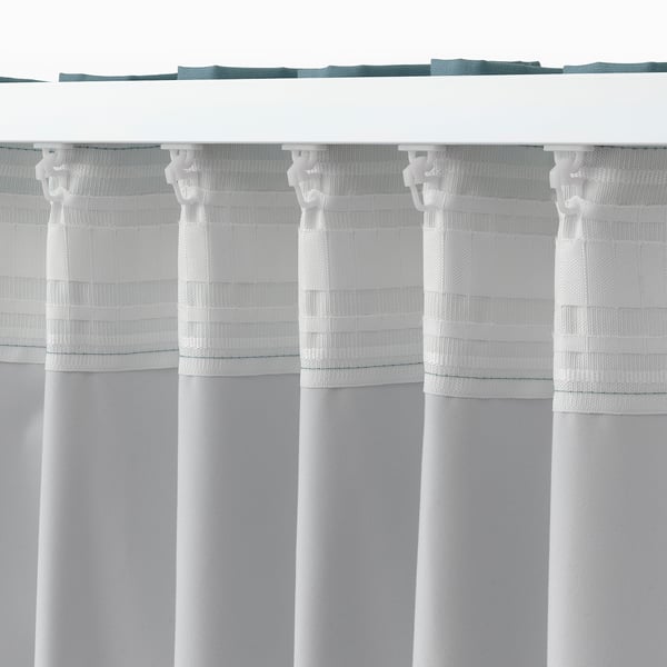 This image shows a white, room-darkening curtain with tabs for hanging. It blocks light and provides privacy.