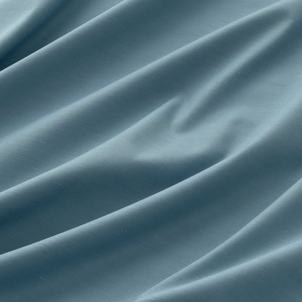 Close-up of textured, triple-weave fabric showcasing intricate, linear patterns and soft, neutral hue, depicting a premium, room-darkening curtain.