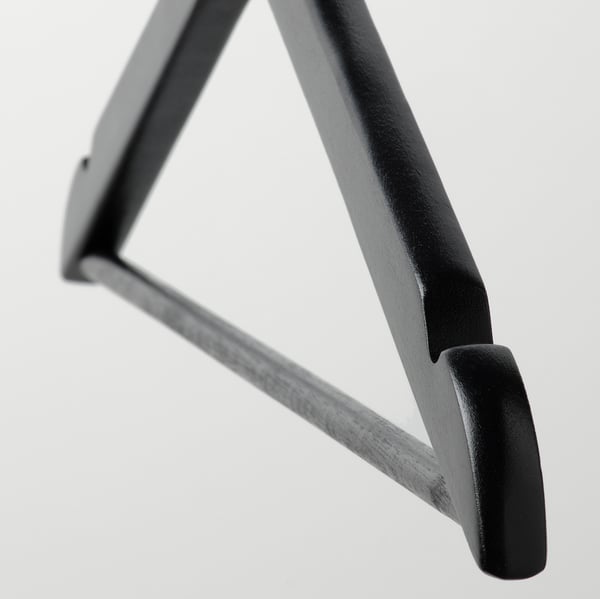 Black metal hanger hook, robust design. Close-up shows smooth, polished surface and sturdy construction.