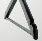 Black metal hanger hook, robust design. Close-up shows smooth, polished surface and sturdy construction.