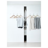 Minimalist closet with BUMERANG hangers, solid wood & chrome, preventing clothes slide.