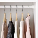 Closet with 6 items on wooden hangers.