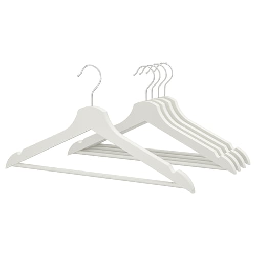 Six light-colored wooden hangers with chrome hooks arranged neatly, designed to keep clothes organised.