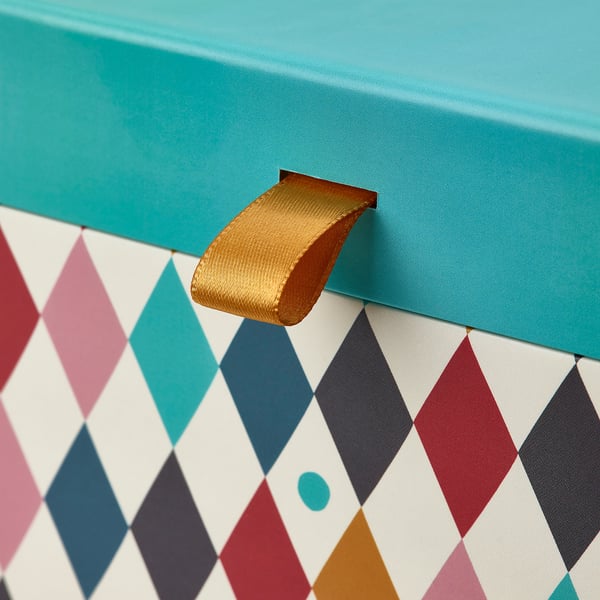 Brightly colored box with gold handle, diamond-patterned compartments, sturdy design.
