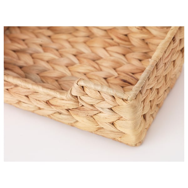 Handwoven water hyacinth napkin holder, showcasing intricate craftsmanship, natural texture, and color variations.